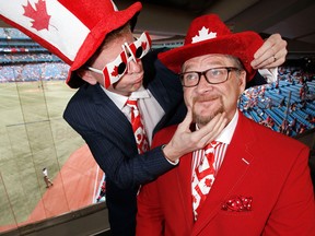 Jamie Campbell fixes Gregg Zaun’s hat in 2013 (CRAIG ROBERTSON/POSTMEDIA)