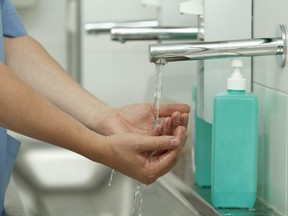 In this stock photo, a doctor washes their hands prior to surgery.