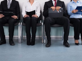 This stock photo shows a group of business people waiting for a job interview.