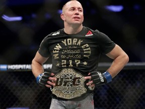 Georges St-Pierre reacts after a middleweight title bout against Michael Bisping at UFC 217 on Nov. 5, 2017