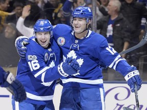 Toronto Maple Leafs centre Patrick Marleau (12) celebrates his game-winning goal against the Boston Bruins with centre Mitchell Marner (16) during overtime NHL hockey action in Toronto on Friday, November 10, 2017. THE CANADIAN PRESS/Nathan Denette