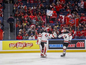 Canada's Cale Makar, right, celebrates his goal with goalie Carter Hart during second period IIHF World Junior Championship preliminary action against Denmark, in Buffalo, N.Y., Saturday, December 30, 2017.