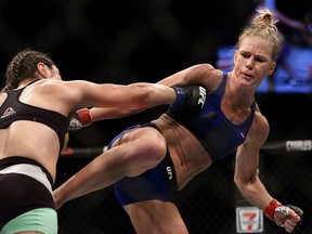 Holly Holm, right, fights Bethe Correia in the women's bantamweight main event bout during UFC Singapore Fight Night on June 17, 2017