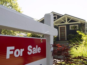 A for sale sign is pictured outside a home in Vancouver in a June, 28, 2016, file photo. (THE CANADIAN PRESS/Jonathan Hayward, File)