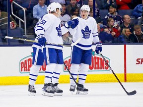 Jake Gardiner of the Toronto Maple Leafs is congratulated by Zach Hyman after scoring a goal on Dec. 20, 2017