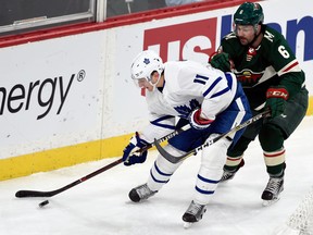 Toronto Maple Leafs winger Zach Hyman handles the puck against Minnesota Wild defenceman Ryan Murphy on Dec. 14, 2017