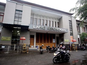 A motorcyclist passes by Kerobokan prison where American citizen Christian Beasley was detained for hashish drug offence, in Bali, Indonesia, Monday, Dec. 11, 2017. (AP Photo/Firdia Lisnawati)