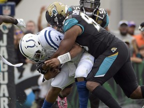 In this Dec. 3, 2017, file photo, Jacksonville Jaguars defensive lineman Calais Campbell, right, sacks Indianapolis Colts quarterback Jacoby Brissett during the first half of an NFL football game, in Jacksonville, Fla.  (AP Photo/Phelan M. Ebenhack, File)