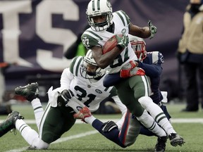New England Patriots cornerback Jonathan Jones, rear, tackles New York Jets wide receiver JoJo Natson (87) during the first half of an NFL football game, Sunday, Dec. 31, 2017, in Foxborough, Mass.