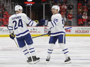 Maple Leafs defenceman Andreas Borgman (right) celebrates his goal against the Detroit Red Wings with Kasperi Kapanen on Friday. (The Associated Press)