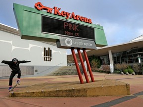 A skateboarder leaps onto a platform in front of KeyArena, a sports and entertainment venue at the Seattle Center on Dec. 4, 2017