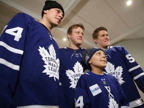 Auston Matthiews, Morgan Rielly and Jake Gardiner with Matthew, 9, at the Hospital for Sick Children in Toronto on Dec. 4, 2017