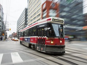 A TTC streetcar crosses Bathurst St. at King St. W. in Toronto, Ont. on Monday, Nov. 13, 2017.