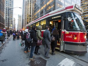 Riders board a TTC streetcar along King St. W., at University Ave. in downtown Toronto on January 26, 2017. (Ernest Doroszuk/Toronto Sun/Postmedia Network)