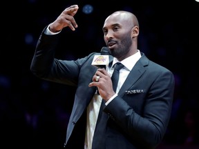 Former Los Angeles Lakers guard Kobe Bryant speaks during a halftime ceremony retiring both of his jersey numbers on Dec. 18, 2017