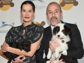 Annette Roque and Matt Lauer pose for a picture with a dog at the 2013 Animal League America Celebrity gala at The Waldorf Astoria on November 22, 2013 in New York City.  (Photo by Mike Coppola/Getty Images)