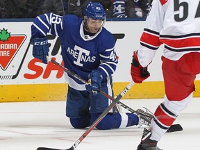 Nazem Kadri of the Toronto Maple Leafs tries to get a shot away from his knees against the Carolina Hurricanes on Dec. 19, 2017