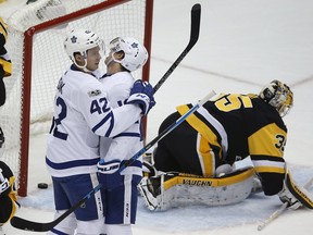 Toronto Maple Leafs' Tyler Bozak (42) celebrates his goal past Pittsburgh Penguins goalie Tristan Jarry (35) with Mitchell Marner, center, in the first period of an NHL hockey game in Pittsburgh, Saturday, Dec. 9, 2017. (AP Photo/Gene J. Puskar)