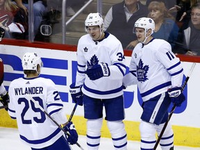 Toronto Maple Leafs center Auston Matthews (34) celebrates his goal against the Arizona Coyotes with Maple Leafs' William Nylander (29) and Zach Hyman (11) during the first period of an NHL hockey game Thursday, Dec. 28, 2017, in Glendale, Ariz.