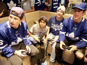 Mitch Marner and Matt Martin play video games with patients at the Hospital for Sick Children in Toronto on Dec. 4, 2017