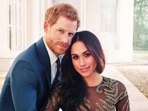 In this handout photo provided by Kensington Palace, Prince Harry and Meghan Markle pose for one of two official engagement photos at Frogmore House in December, 2017 in Windsor, United Kingdom. (Alexi Lubomirski via Getty Images)
