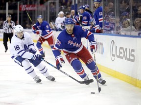 Rangers’ Kevin Shattenkirk skates for the puck against the Leafs’ Mitch Marner last night. (Getty Images)