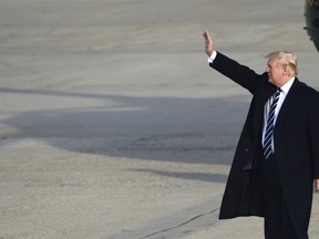 President Donald Trump walks up the steps of Air Force One at Andrews Air Force Base in Md., Saturday, Dec. 2, 2017. Trump is heading to New York to attend Republican fundraisers.