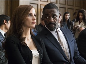 This image released by STXfilms shows Idris Elba, right, and Jessica Chastain in a scene from "Molly's Game." (Michael Gibson/STXfilms via AP)