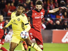 Columbus Crew forward Ola Kamara (11) and Toronto FC defender Drew Moor (3) battle for the ball during first half MLS eastern conference semifinal playoff soccer action in Toronto on Wednesday, November 29, 2017. THE CANADIAN PRESS/Nathan Denette
