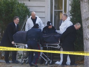 The body of a woman is removed from her home on Bathgate Dr. in Scarborough's east end  on Wednesday, Dec. 6, 2017.  (Chris Doucette/Toronto Sun)