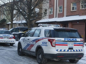 Toronto Police cars remain outside of a Malvern townhouse, near Morningside and McLevin Aves., Tuesday afternoon. Officers were initially called there for a medical distress call, but found a woman dead. Homicide is now investigating.