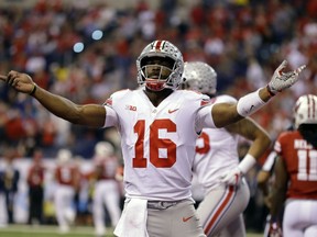 Ohio State quarterback J.T. Barrett celebrates after a 1-yard touchdown run during the first half of the Big Ten championship NCAA college football game against Wisconsin, Saturday, Dec. 2, 2017, in Indianapolis.