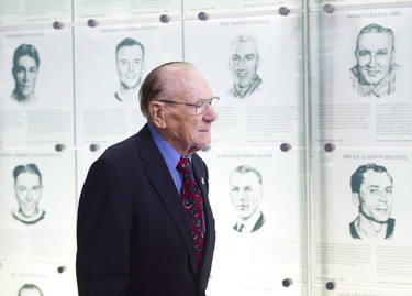 Hockey Hall of Famer Johnny Bower walks to his seat as The Hockey Hall of Fame officially unveiled the "Esso Great Wall" as home to the Stanley Cup, all major NHL trophies and recognition structures for individuals elected into Honoured Membership in Toronto on March 9, 2012. THE CANADIAN PRESS/Nathan Denette