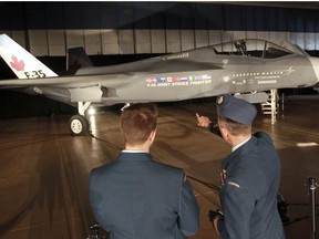 A Canadian Forces members look at the Lockheed Martin Joint Strike Fighter, F-35 Lighting II in a hanger in Ottawa Friday July 16, 2010. The Peter MacKay, Minister of National Defence announced that the government of Canada will buy 65 of these Joint Strike fighters and they are expected to be delivered in 2016. (ANDRE FORGET / QMI AGENCY)