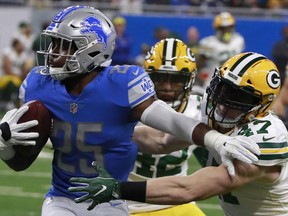 Detroit Lions running back Theo Riddick (25) is stopped by Green Bay Packers inside linebacker Jake Ryan (47) during the first half of an NFL football game, Sunday, Dec. 31, 2017, in Detroit.
