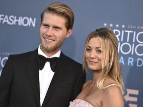 FILE - In this  Dec. 11, 2016, file photo, Kaley Cuoco, right, and Karl Cook arrive at the 22nd annual Critics' Choice Awards at the Barker Hangar in Santa Monica, Calif. The couple announced their engagement on Nov. 30, 2017. (Photo by Jordan Strauss/Invision/AP, File)