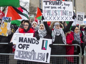 A crowd protests across the street from the US Consulate General along University Ave. in Toronto, Ont. on Sunday December 10, 2017. They were protesting US president Donald Trump's moved recognizing Jerusalem as the capital of Israel.  (ERNEST DOROSZUK/TORONTO SUN)