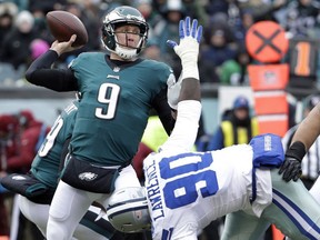 Philadelphia Eagles' Nick Foles (9) passes over Dallas Cowboys' DeMarcus Lawrence (90) during the first half of an NFL football game, Sunday, Dec. 31, 2017, in Philadelphia.