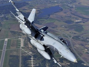 A CF-188 Hornet from the Canadian Air Task Force Lithuania perform manoeuvres over Lithuania on September 15, 2014 for the NATO Baltic Air Policing Block 36 during Operation REASSURANCE. (Cpl Gabrielle DesRochers)