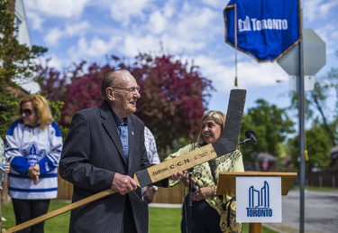 Former Toronto Maple Leaf goaltender and hockey legend Johnny Bower poses with a goalie hockey stick before a ceremonial road-naming ceremony on Patika Avenue  - now aka. Johnny Bower Blvd. - in northwest Toronto, Ont. on Saturday May 24, 2014.  Ernest Doroszuk/Toronto Sun