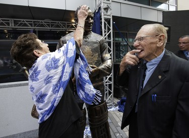 Johnny Bower shows his wife Nancy they added teeth to his bronzed statue and she admires the full head of hair on Saturday September 6, 2014. Craig Robertson/Toronto Sun