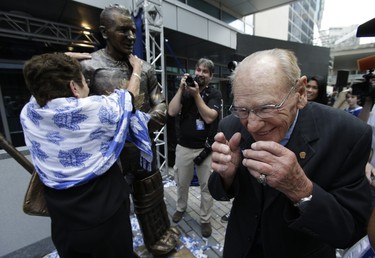 Johnny Bower's wife Nancy turns to hug the statue when asked to give Johnny a hug on Legends Row on Saturday September 6, 2014. Craig Robertson/Toronto Sun