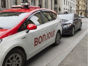 A taxi with Bonjour on the side is seen Thursday, November 30, 2017 in Montreal. The National Assembly is formally asking Quebec's merchants to "warmly" greet their clients with the word "Bonjour," and drop the old standard "Bonjour-hi."