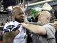 A Seattle Seahawks staff member tries to remove Seahawks defensive tackle Quinton Jefferson, left, from the field as an object thrown from the stands hits them during the closing moments of an NFL football game against the Jacksonville Jaguars, Sunday, Dec. 10, 2017, in Jacksonville, Fla. Jacksonville won 30-24. (AP Photo/Stephen B. Morton)