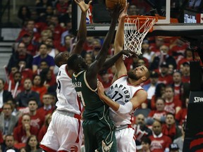 Toronto Raptors forwards Jonas Valanciunas and Serge Ibaka double team Milwaukee Bucks' Thon Maker on April 18, 2017