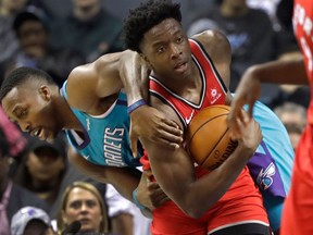Toronto Raptors' OG Anunoby, right, steals the ball from Charlotte Hornets' Dwight Howard on Dec. 20, 2017
