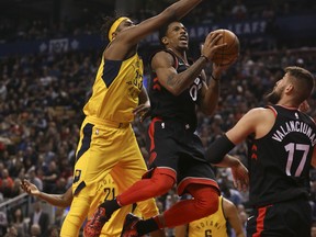Toronto Raptors' DeMar DeRozan is fouled by Indiana Pacers' Myles Turner during an NBA game at the Air Canada Centre on Dec. 1, 2017