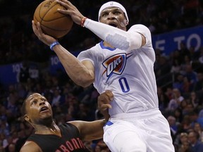 Oklahoma City Thunder guard Russell Westbrook (0) goes up for a shot past Toronto Raptors guard Kyle Lowry (7) in the third quarter of an NBA basketball game in Oklahoma City, Sunday, March 8, 2015. Oklahoma City won 108-104. (AP Photo/Sue Ogrocki)