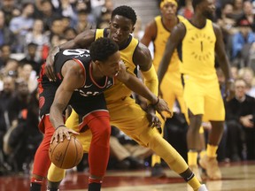 Toronto Raptors DeMar DeRozan (1) is guarded by in the fourth quarter in Toronto, Ont. on Friday December 1, 2017. Jack Boland/Toronto Sun/Postmedia Network