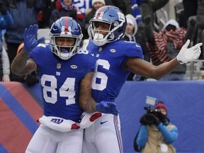 New York Giants wide receiver Hunter Sharp (84) celebrates with teammate Marquis Bundy (86) after catching a pass for a touchdown during the first half of an NFL football game against the Washington Redskins, Sunday, Dec. 31, 2017, in East Rutherford, N.J.